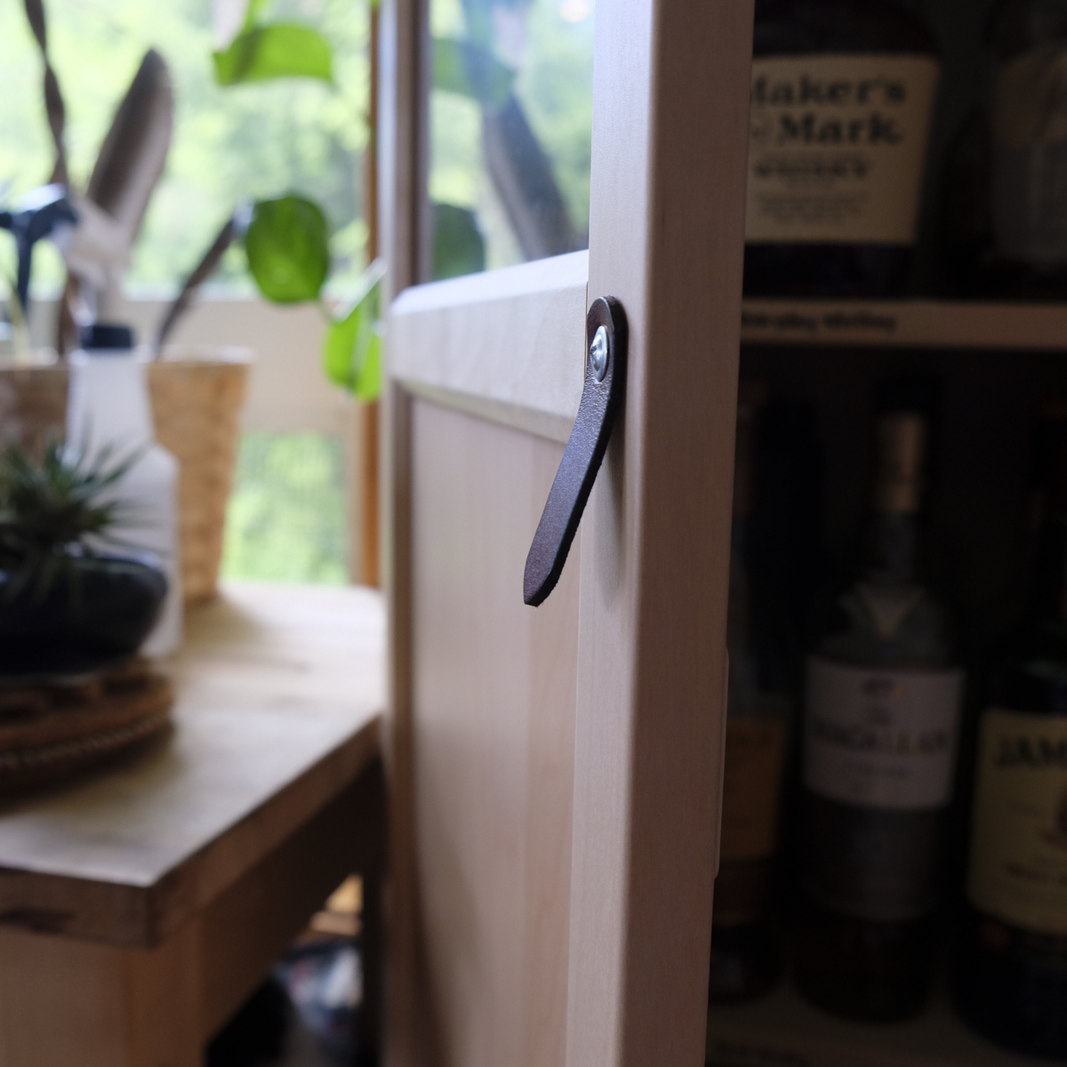 Side view of the St. Johns leather pull, with the door open, showing the handle was sold with no hardware and was secured directly into the door with a wood screw.