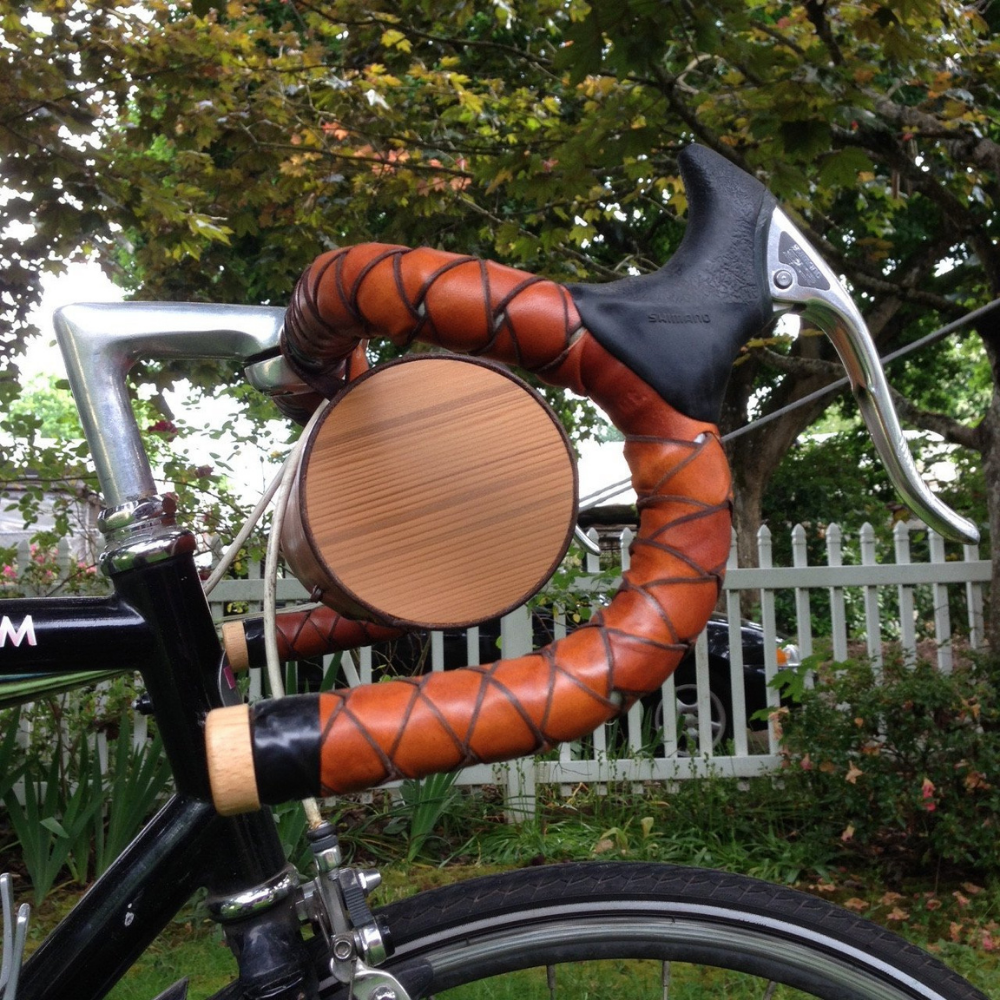 Close-up side view of wooden ends of bicycle barrel bag while mounted on bike