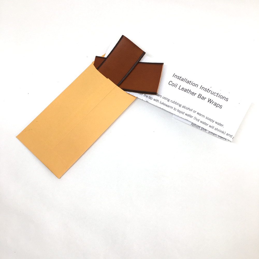 White background photo of the installation kit that comes with the bar wraps: a coin envelope with gap fillers and instructions
