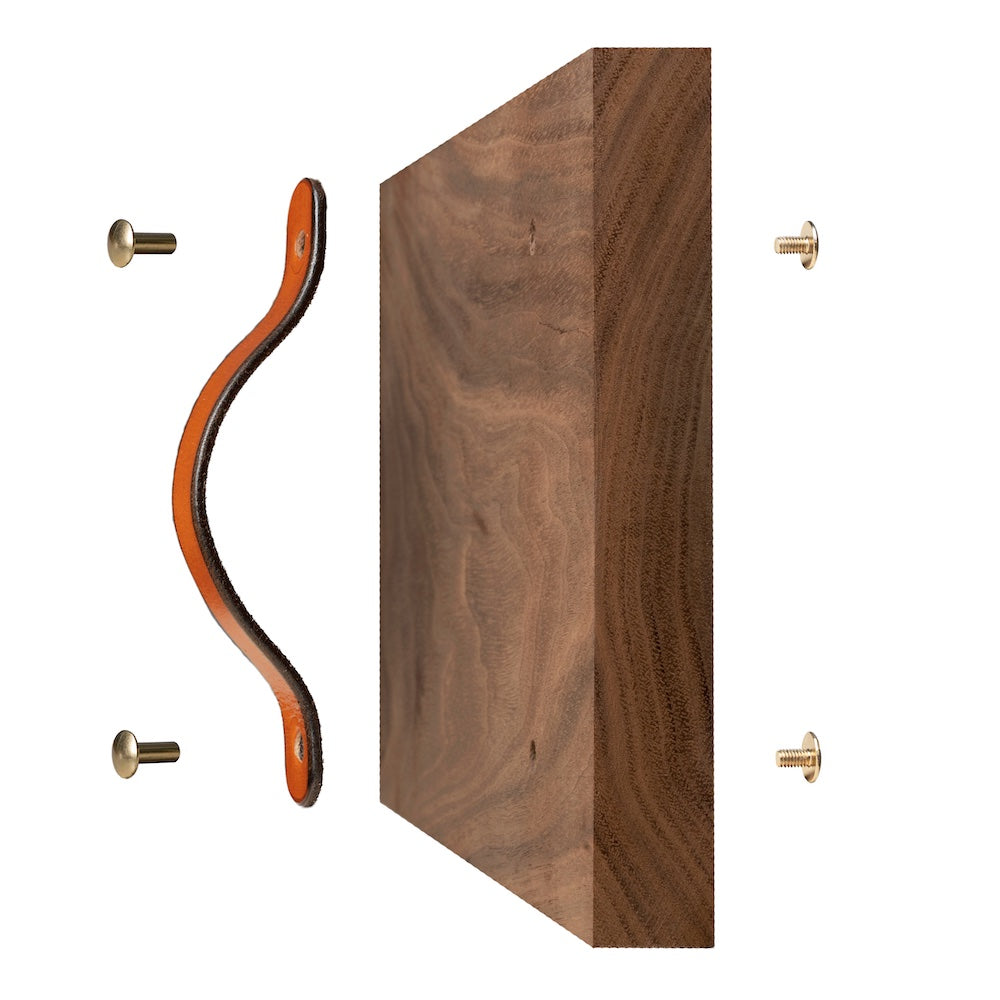 Walnut Studiolo Drawer Pulls Leather Drawer Pull - The Flanders - image of handle being installed on a walnut wood board, showing the Chicago screws in front, holes in the door, and back screws to secure