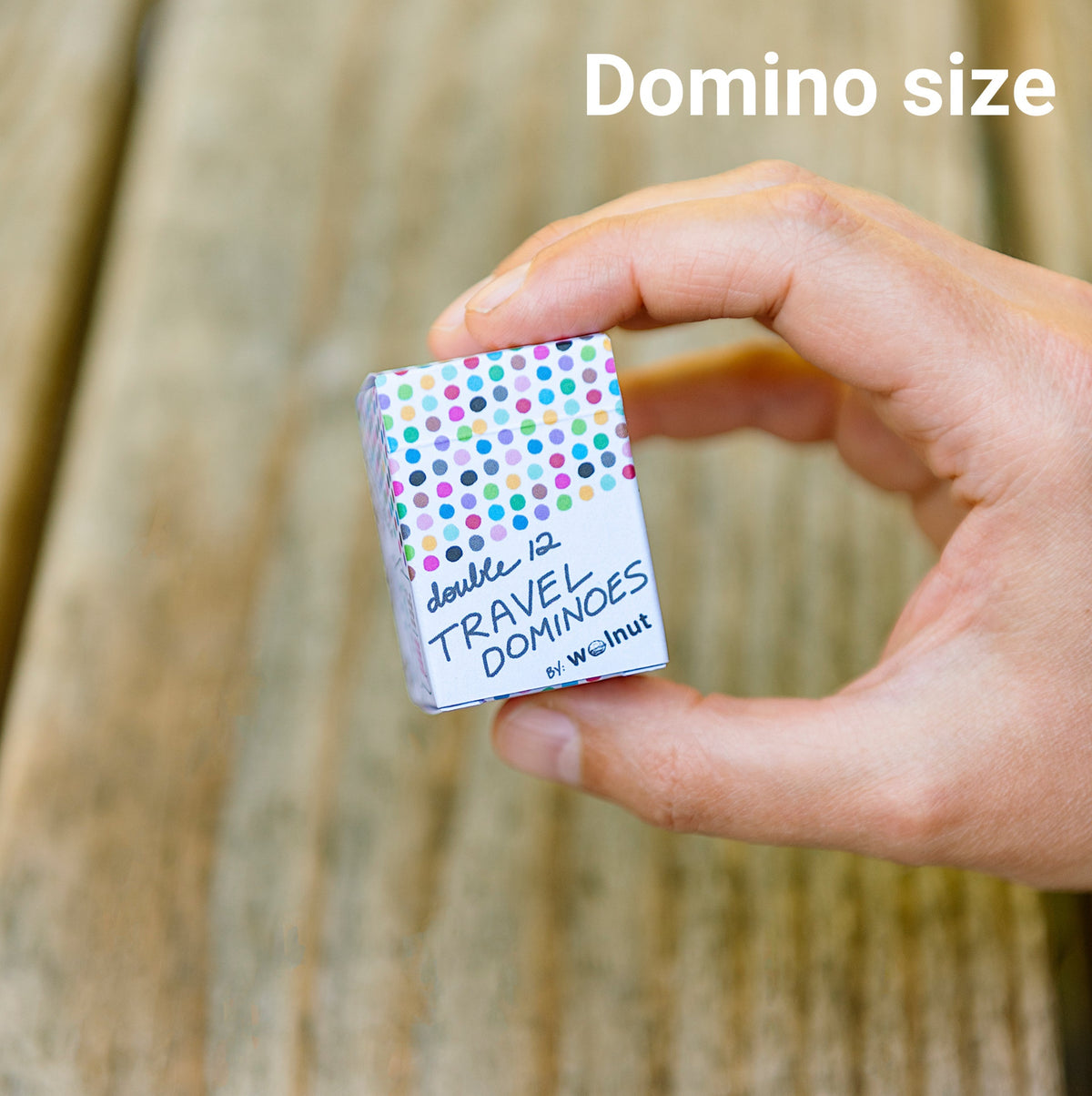 Hand holding domino size cards for scale