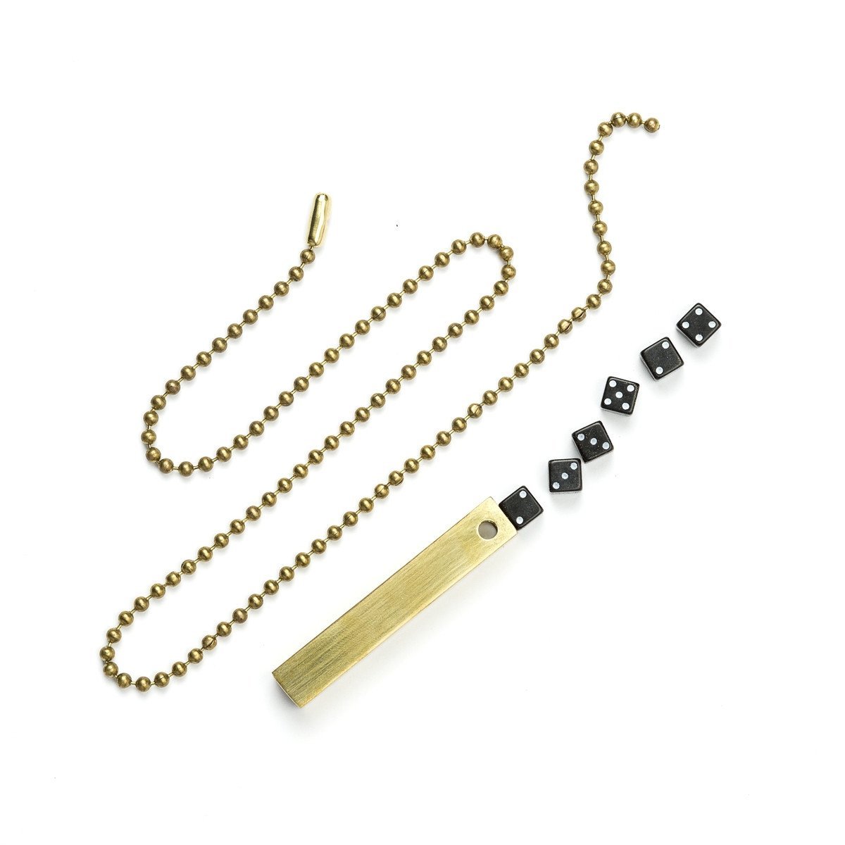 White background variant photo of brass travel dice with black dice and a necklace chain