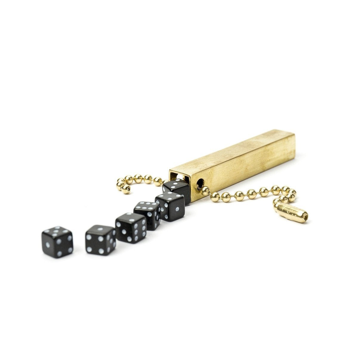 White background variant photo of brass travel dice with black dice and a keychain