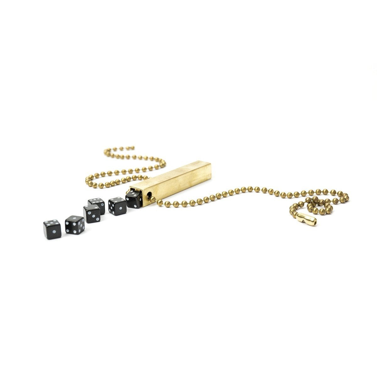 White background variant photo of brass travel dice with black dice and a necklace chain