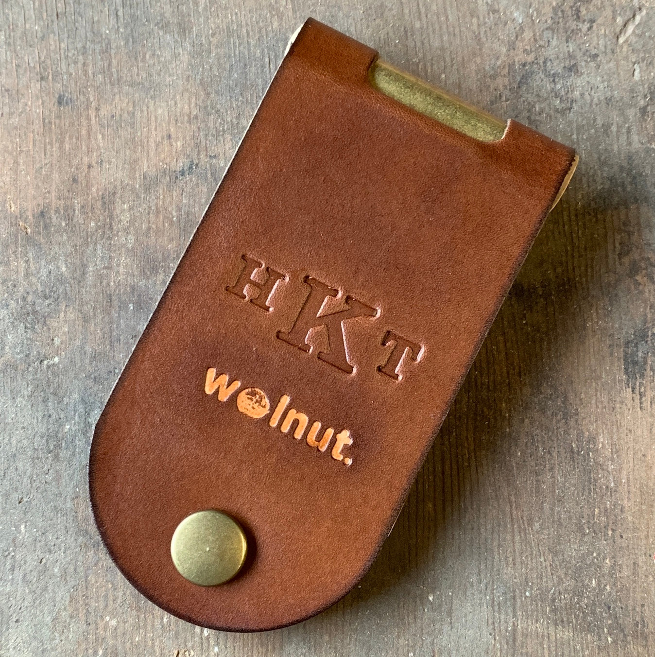 A monogrammed leather folding cribbage board with formal initials