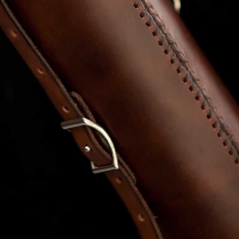 Close-up of a Conway buckle on a dark brown leather Blueprint tube shoulder strap