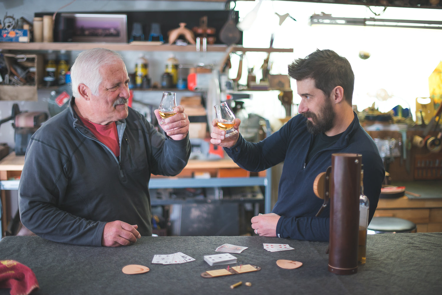 Geoff and his dad Mike in the workshop playing travel cribbage and drinking whiskey
