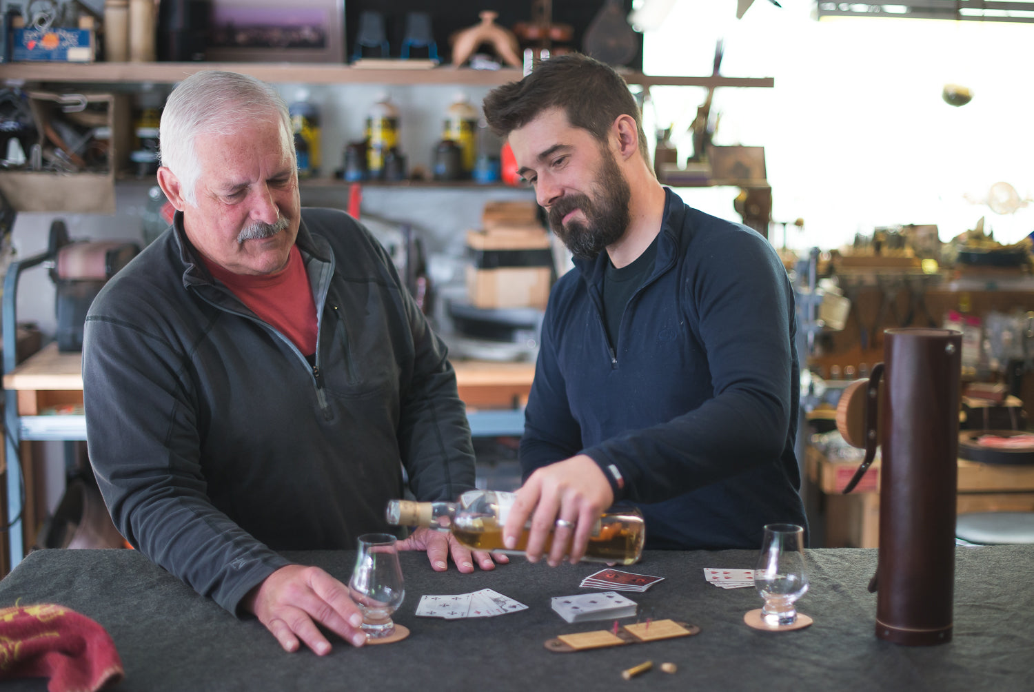 Geoff and his dad Mike sharing whiskey and a game of cribbage in the workshop