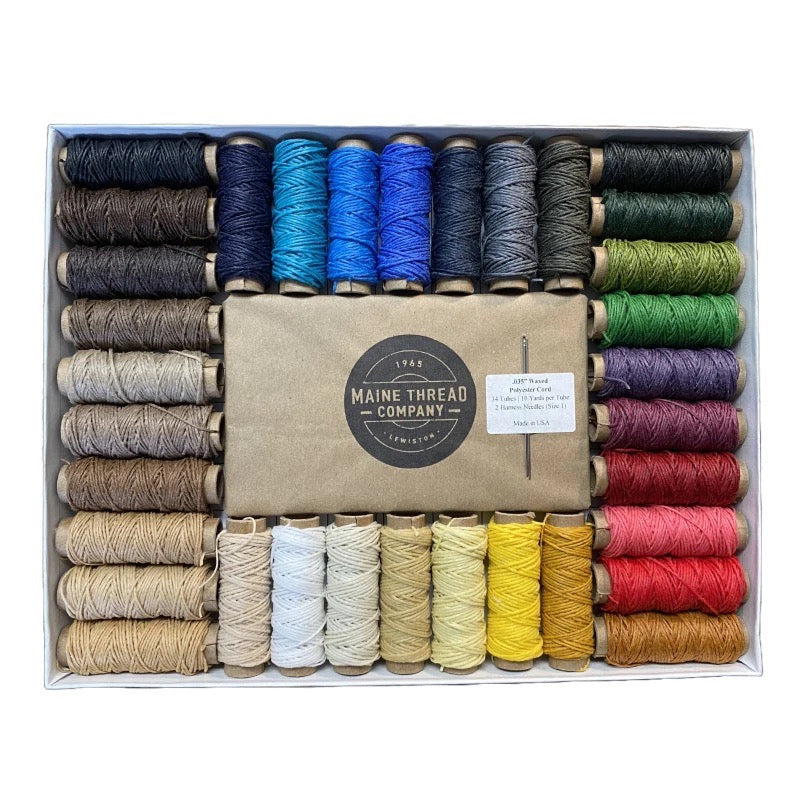 A rainbow of different thread spindles in many colors from Maine Thread Company