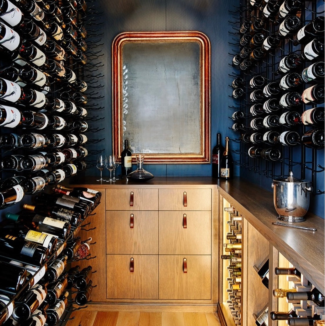 Wine cellar remodel featuring hawthorne leather handles with deep blue walls