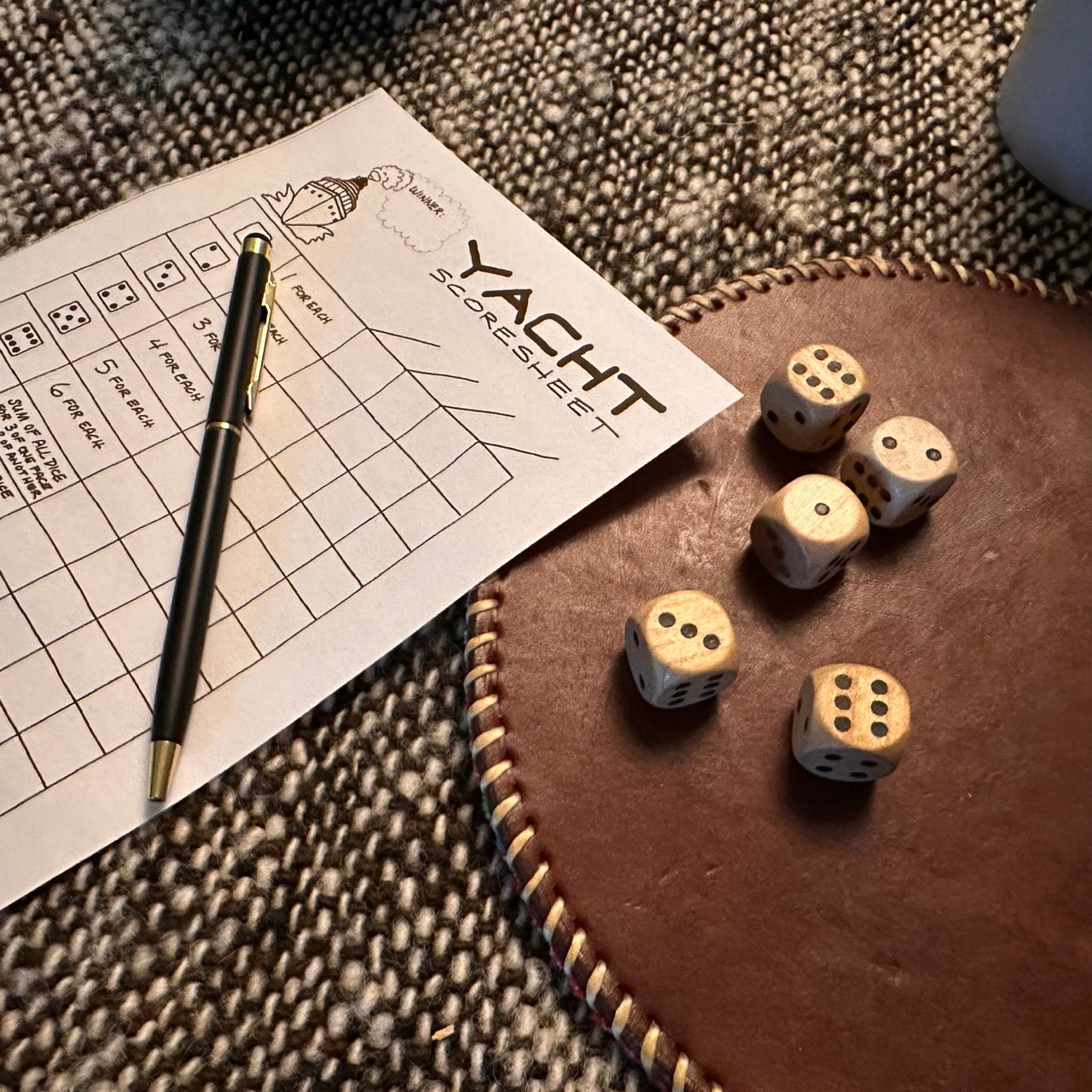 A wood dice game with a scorecard Yacht