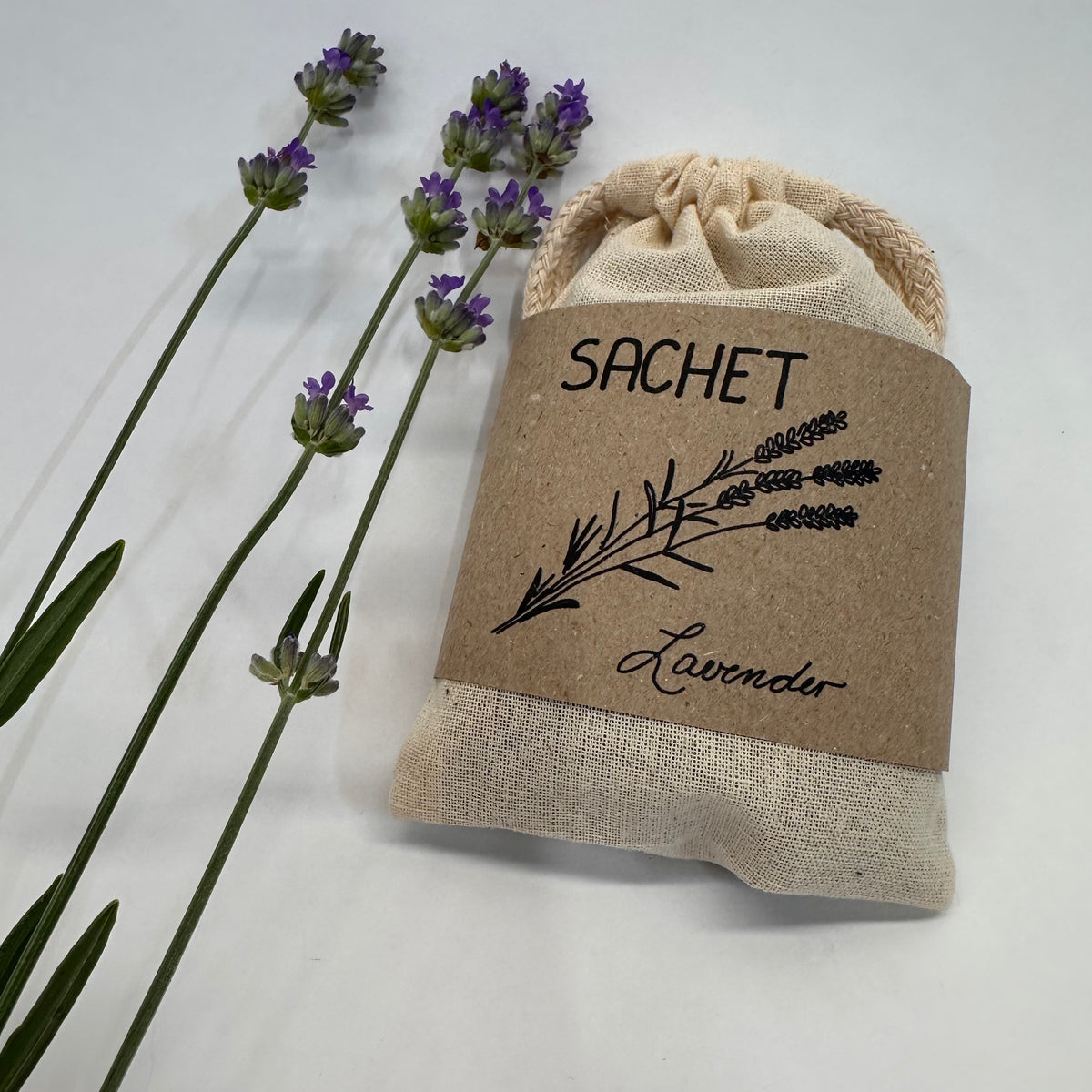 Lavender sachet with lavender flowers on a white background