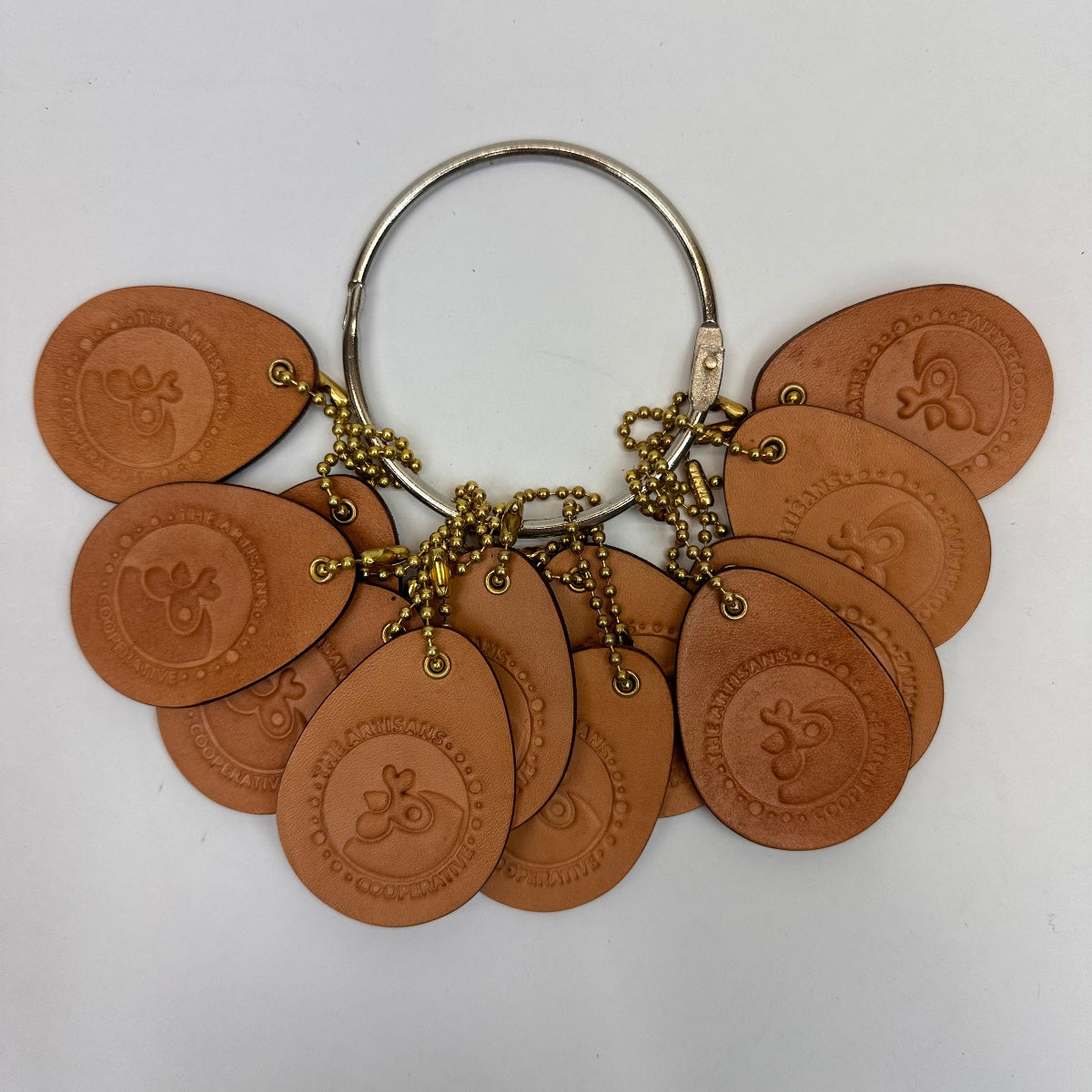 Keychain with brown circular tags and gold chain on a white background