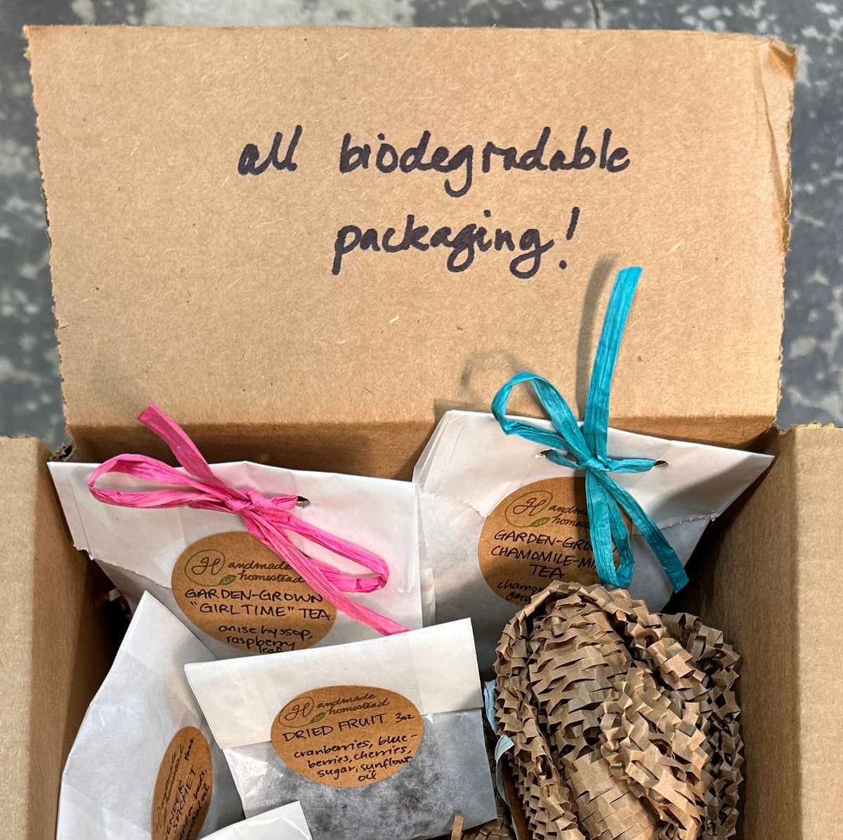 Box of neatly-packeged items with biodegradable packaging label