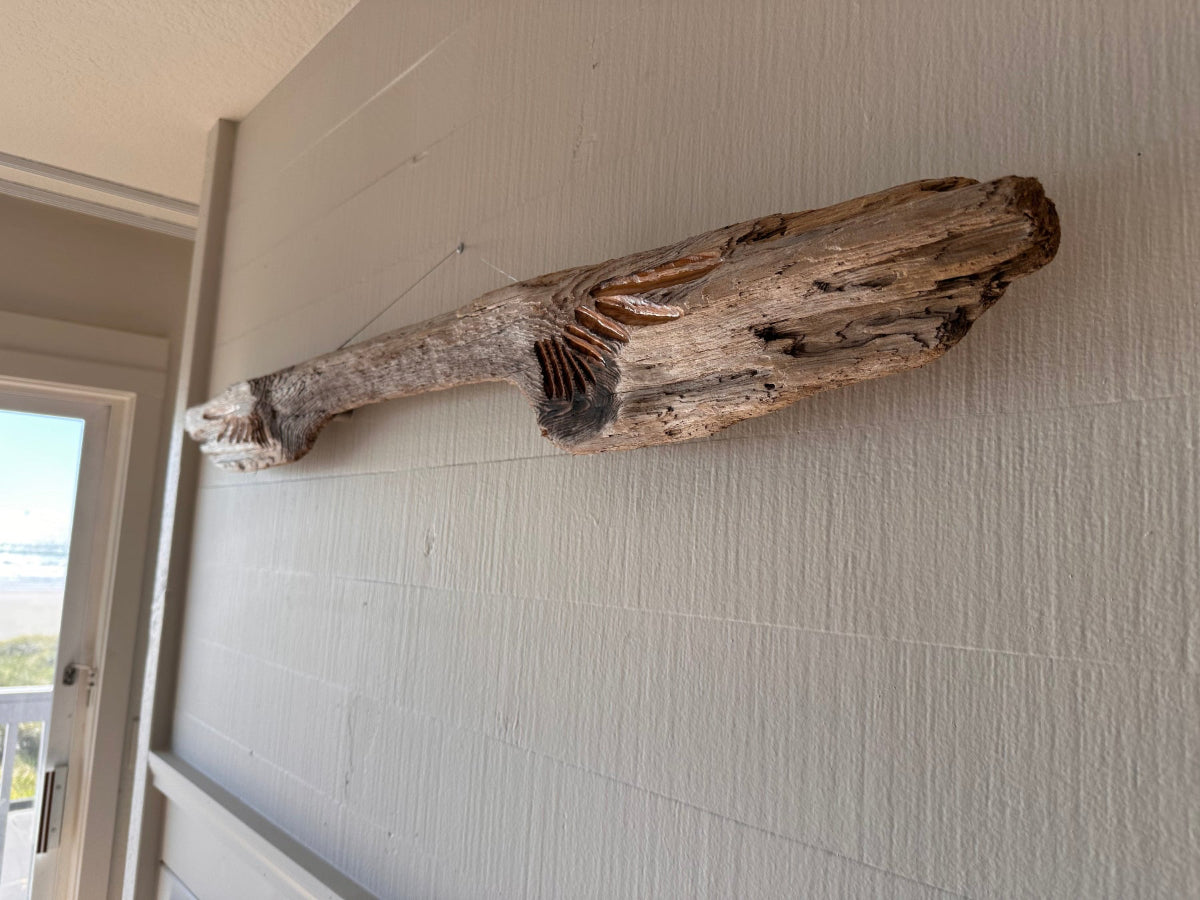 Driftwood piece mounted on a wall seen from an angle