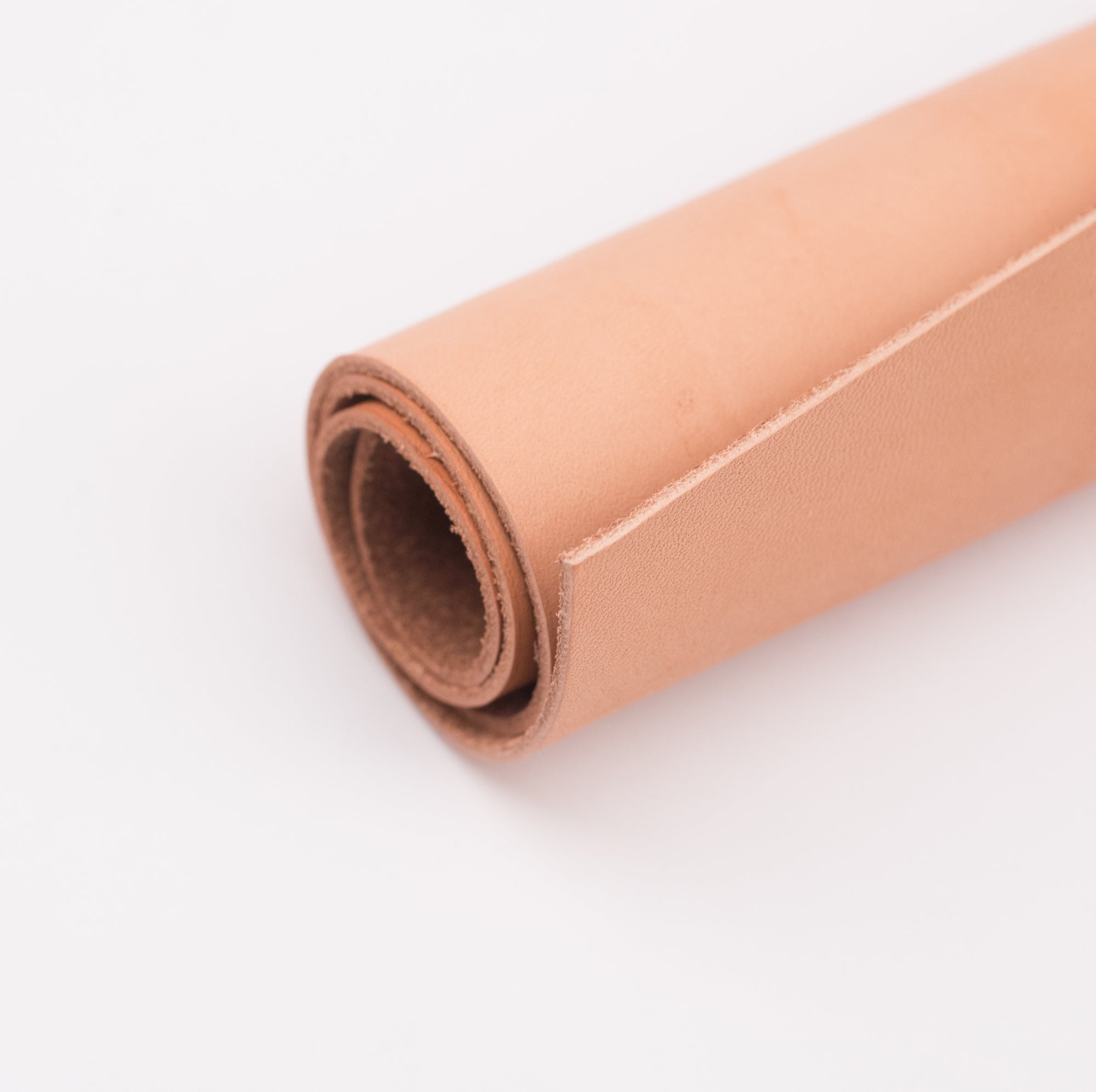 A roll of natural leather on a white background