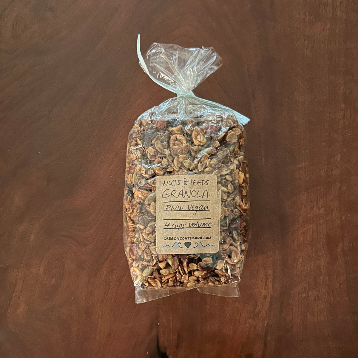 Packaged bag of granola on a wooden surface with a visible label 4 cups