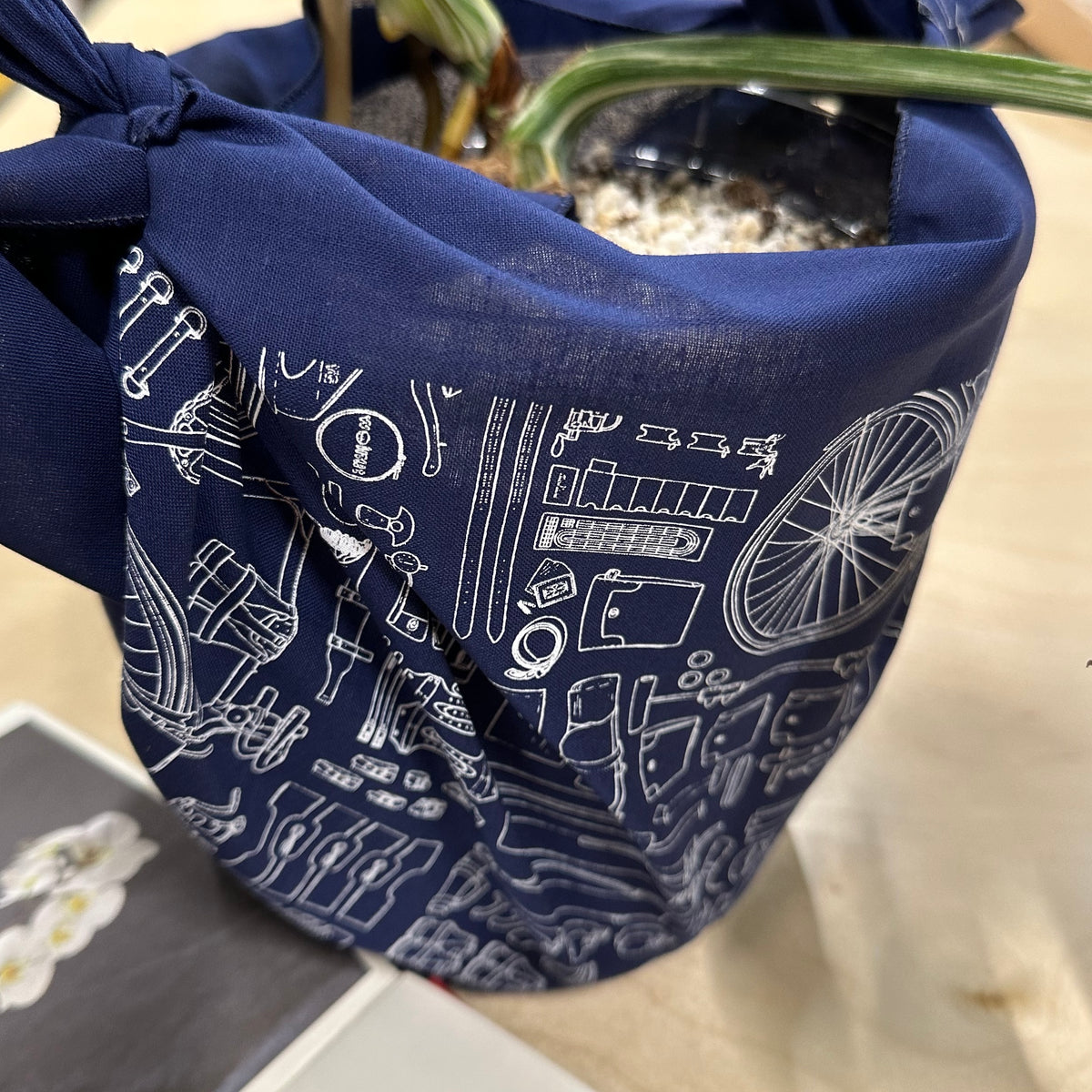 A gift wrapped in a navy blue furoshiki cloth bandana