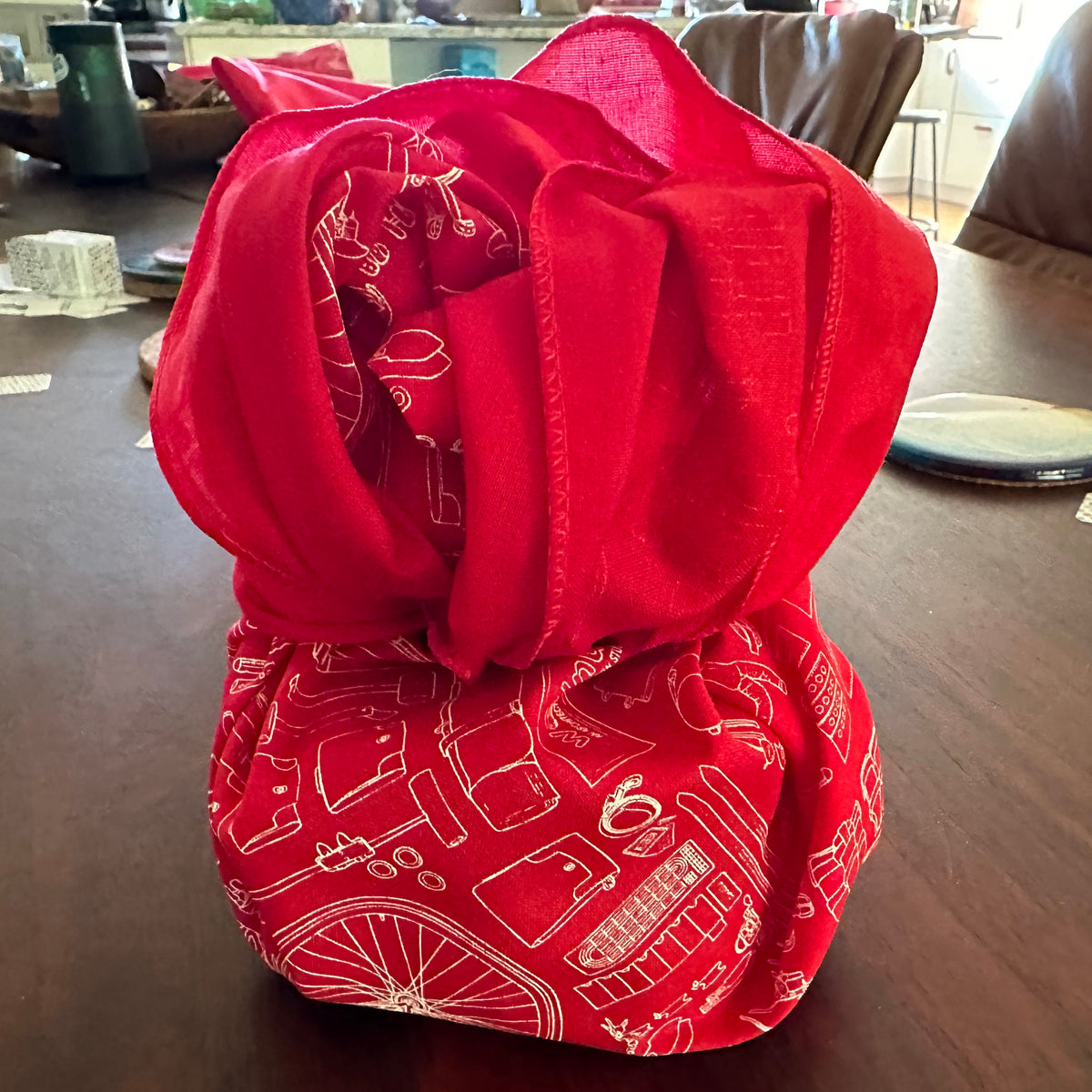 A gift wrapped in a red furoshiki cloth bandana