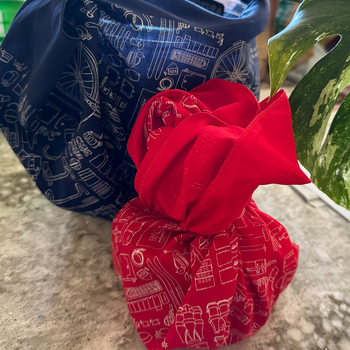 Two gifts wrapped in a navy blue and red furoshiki cloth bandana