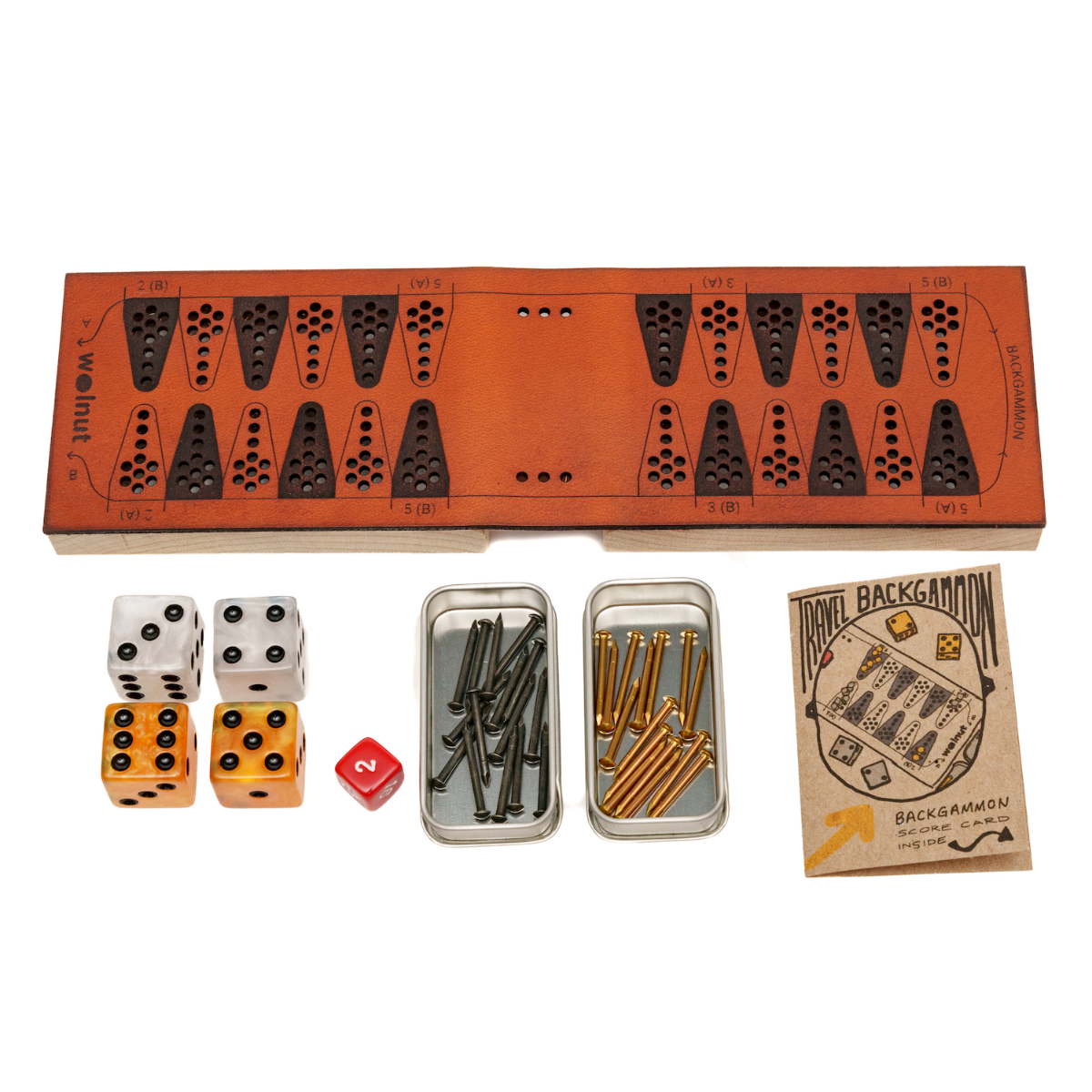 White background photo of a leather travel backgammon board opened up and all the parts to the side: marbleized resin dice, a small red doubling cube, slider tins with brass and black nails, and a little booklet with score card