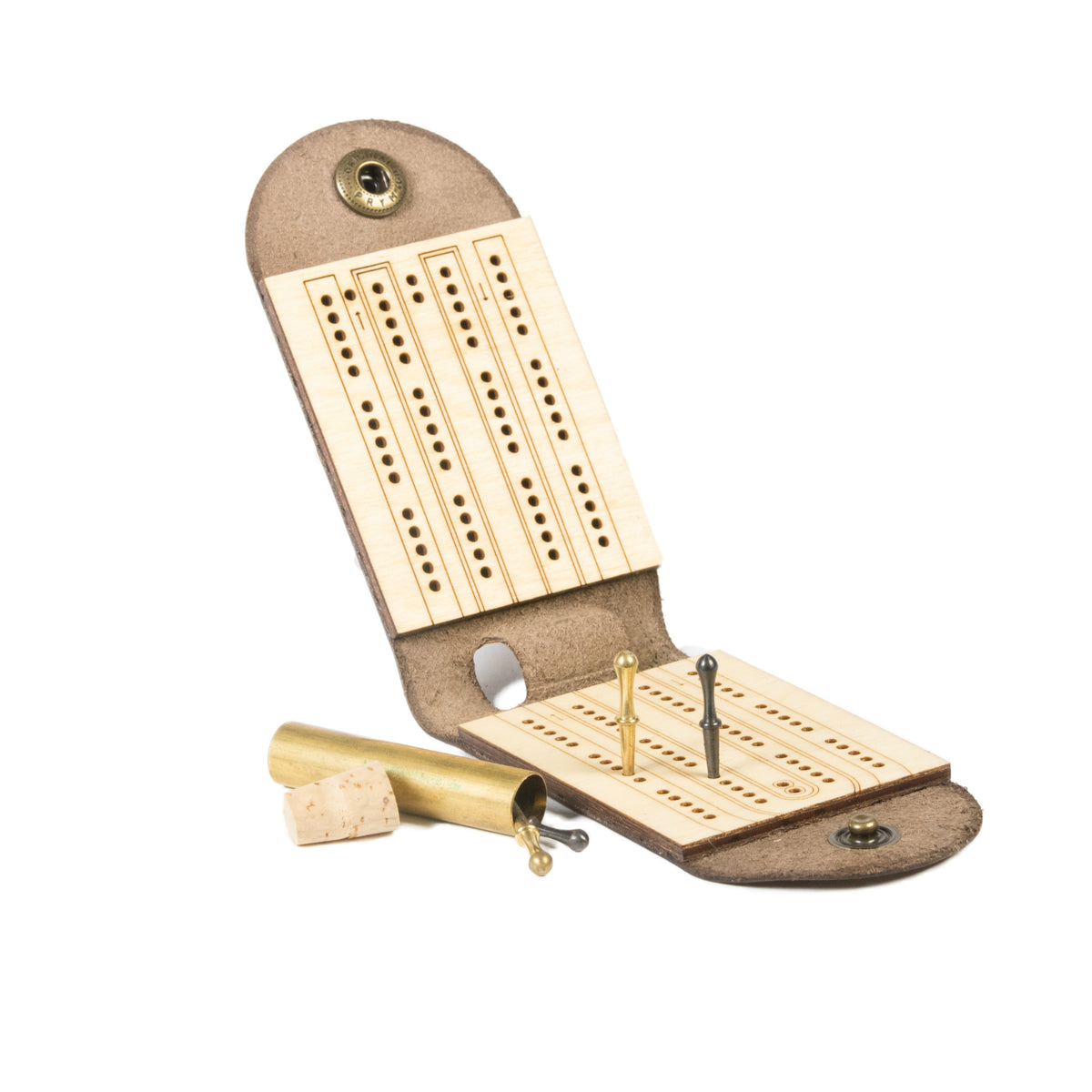 Folding leather travel cribbage board, open and unhinged, showing cast metal pegs in brass and black finishes in peg holes, and an uncorked brass tube that stores the pegs inside the hinge.