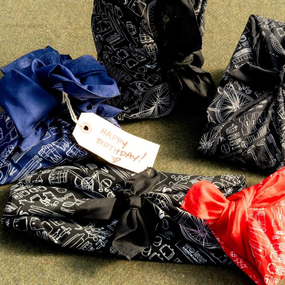 A collection of gifts wrapped with furoshiki bandanas in all colors