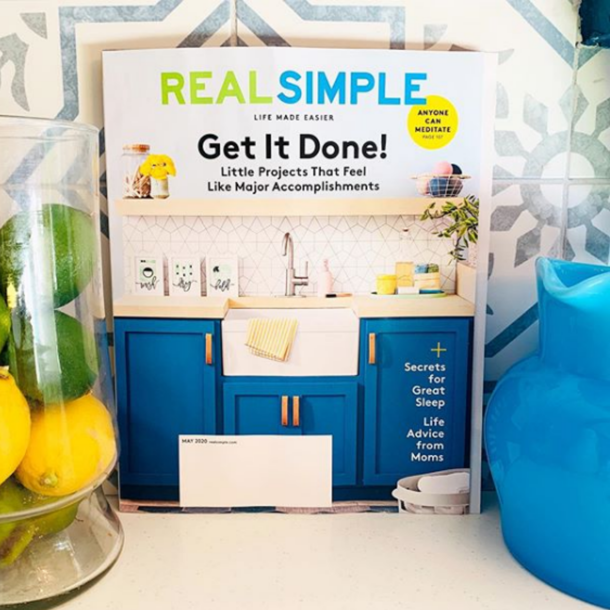 Shows this Walnut Studiolo leather handle on the front cover of Real Simple Magazine. The magazine is propped up on a kitchen counter. 