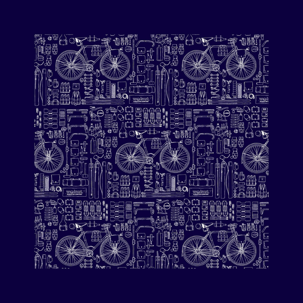 Blue version of bicycle print bandana. Print is repeated with a thick black border and features a bicycle with a variety of walnut studiolo accessories. The drawings are of a technical blueprint style.