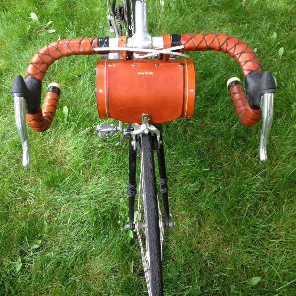 Front view of honey leather bicycle bag with locking mechanism while mounted on bike