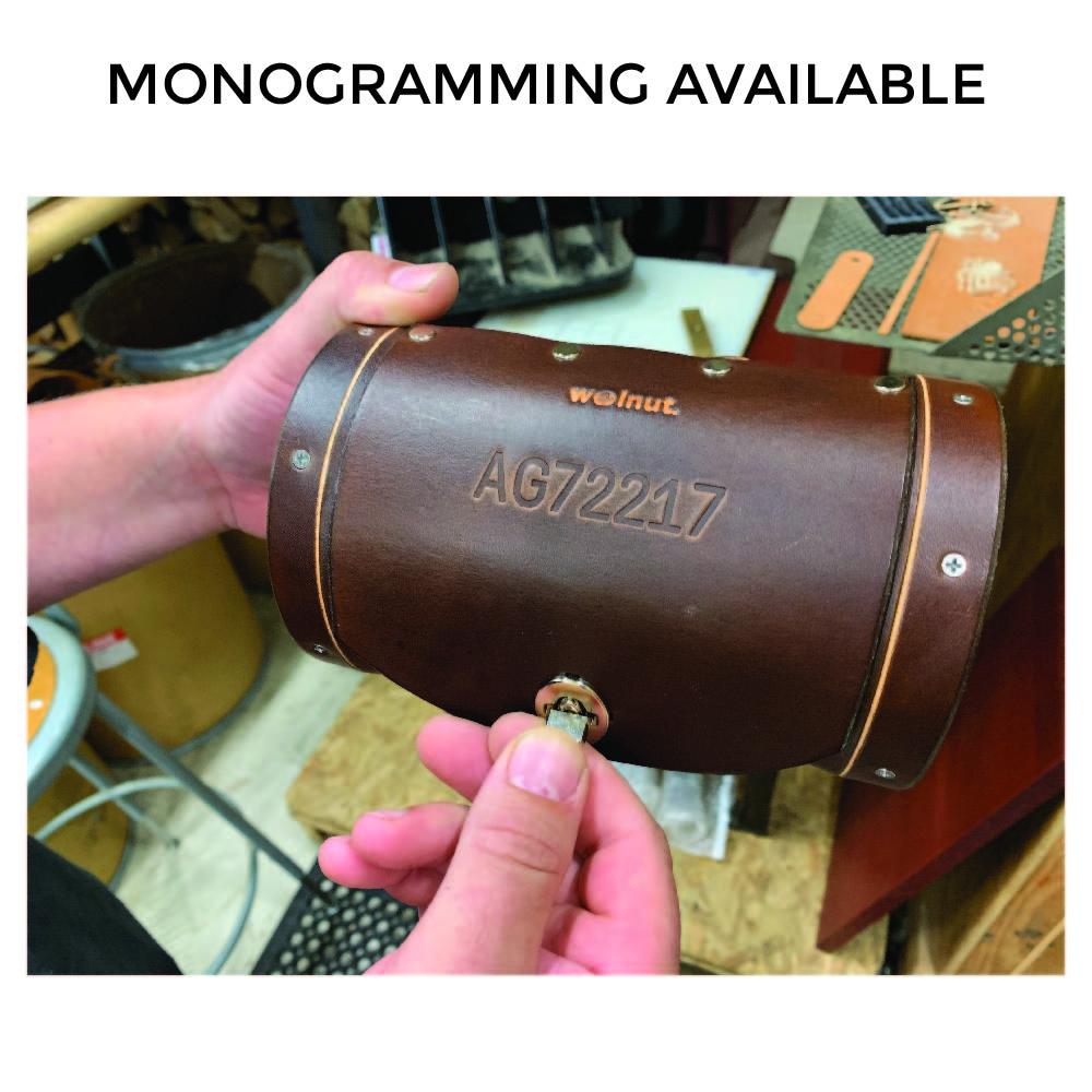 Dark brown leather bicycle handlebar bag being locked. Bag has debossing that reads &amp;quot;AG72217.&amp;quot; Text above the image reads &amp;quot;Monogramming Available.&amp;quot;