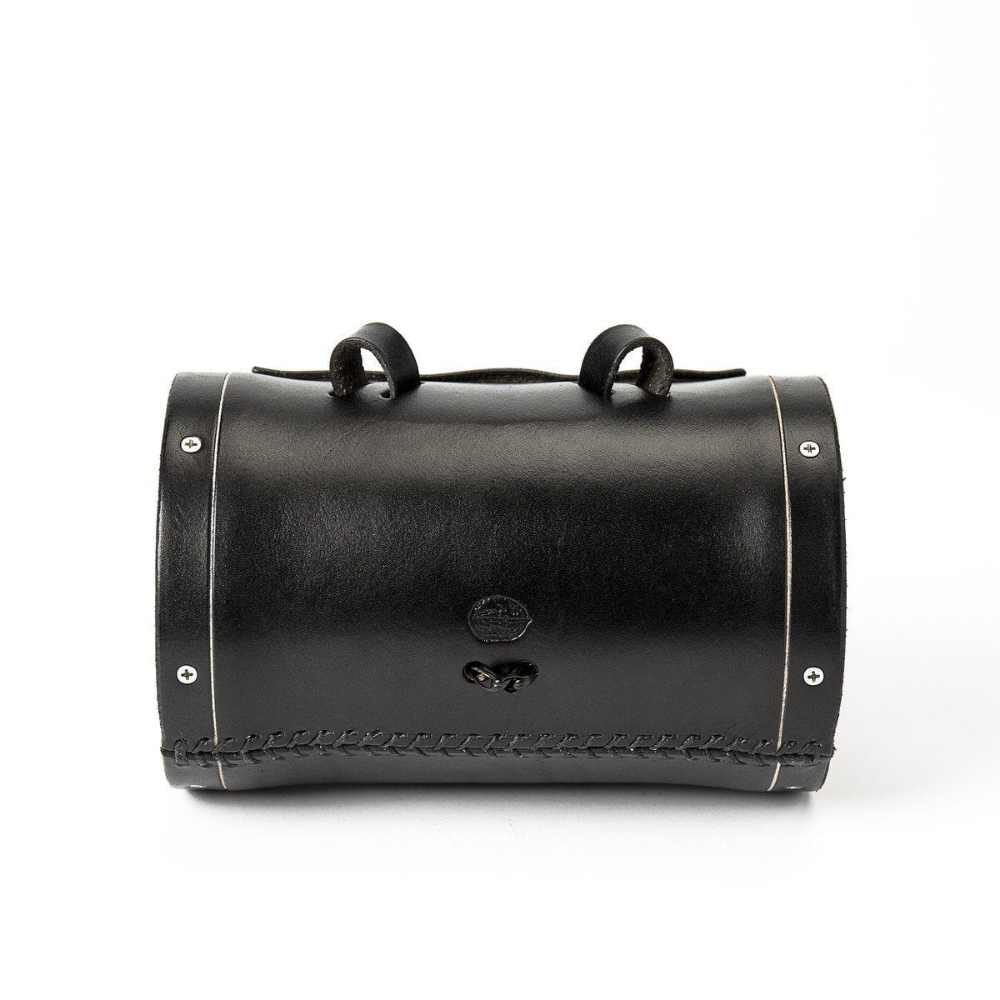Back side of black leather barrel bag shows 3 points of connection to bicycle with silver-look hardware