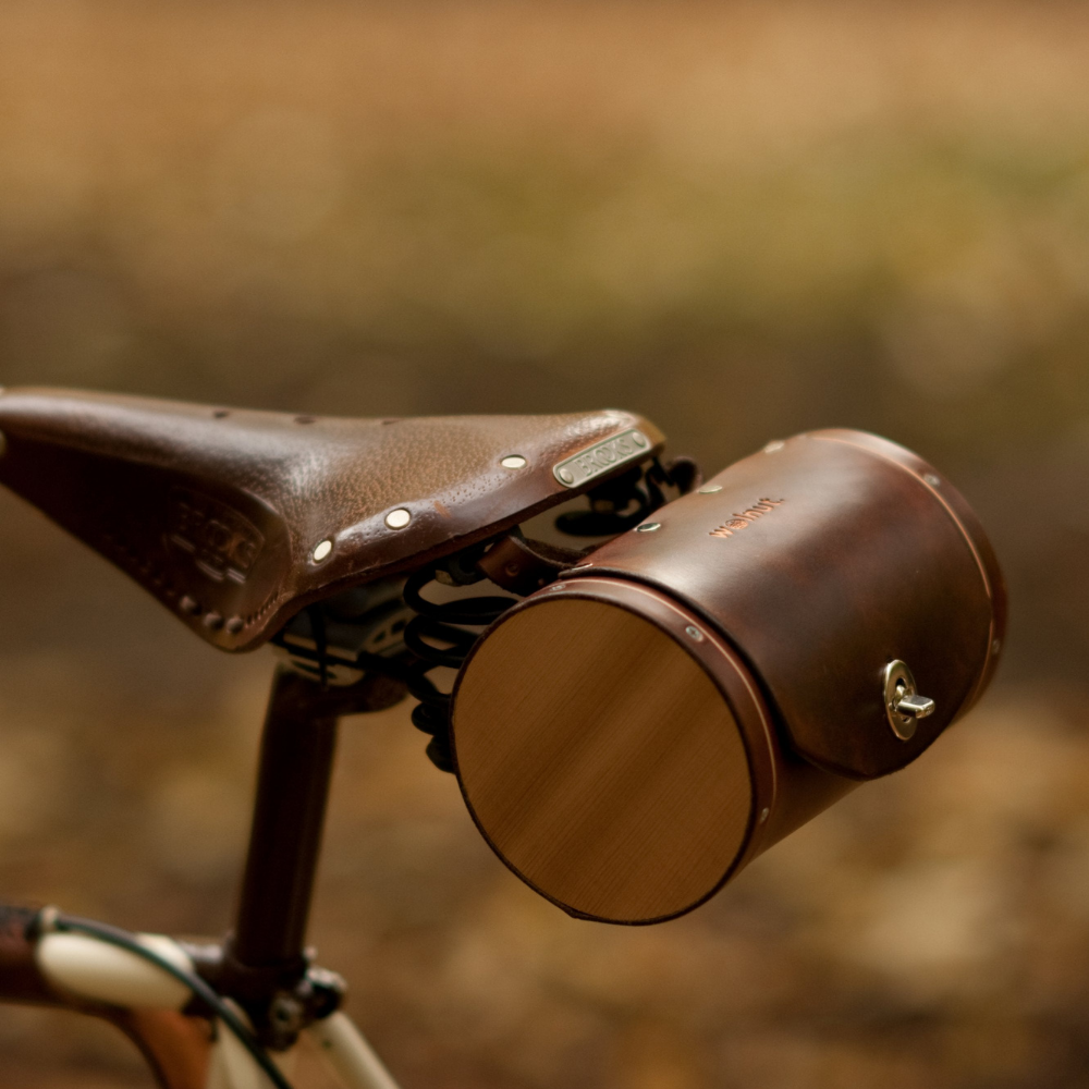 Dark brown leather barrel bicycle bag mounted on Brooks bike seat