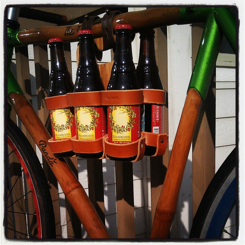 Customer photo of a Honey / Bamboo 6-pack held to the top tube of a bamboo Panda bicycle with a dark brown leather 6-pack carrier strap
