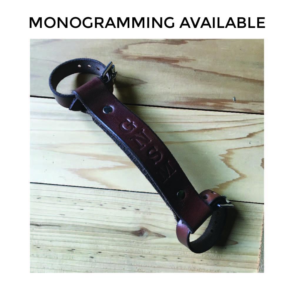 Dark brown leather bike handle on wooden table with debossing &quot;GNSM&quot; under text that reads &quot;Monogramming Available&quot;