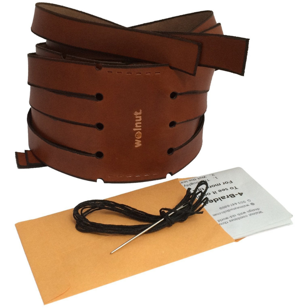 White background photo showing the bullwhip braided leather bar wraps kit as it looks out of the box: two leather wraps coiled up, and a coin envelope containing instructions, needle, and thread.