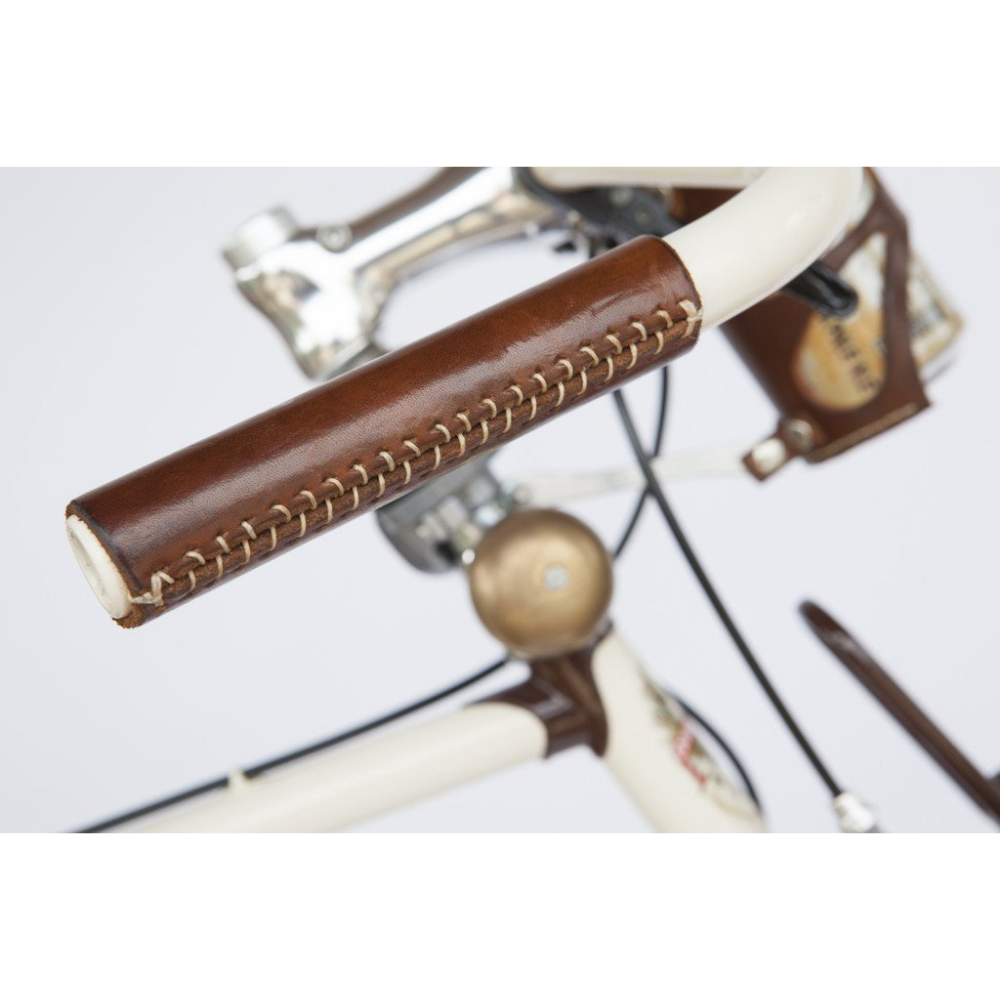 Close-up of white thread stitching on dark brown bicycle leather handlebar grip