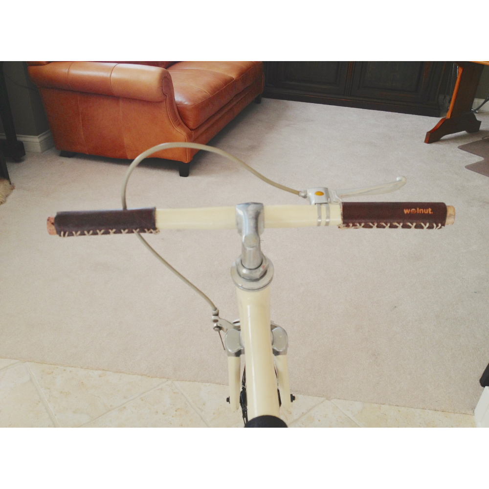 Customer photo showing a unique style of stitching on a dark brown leather grip and a very short and narrow handlebar, with DIY wine cork bar plugs