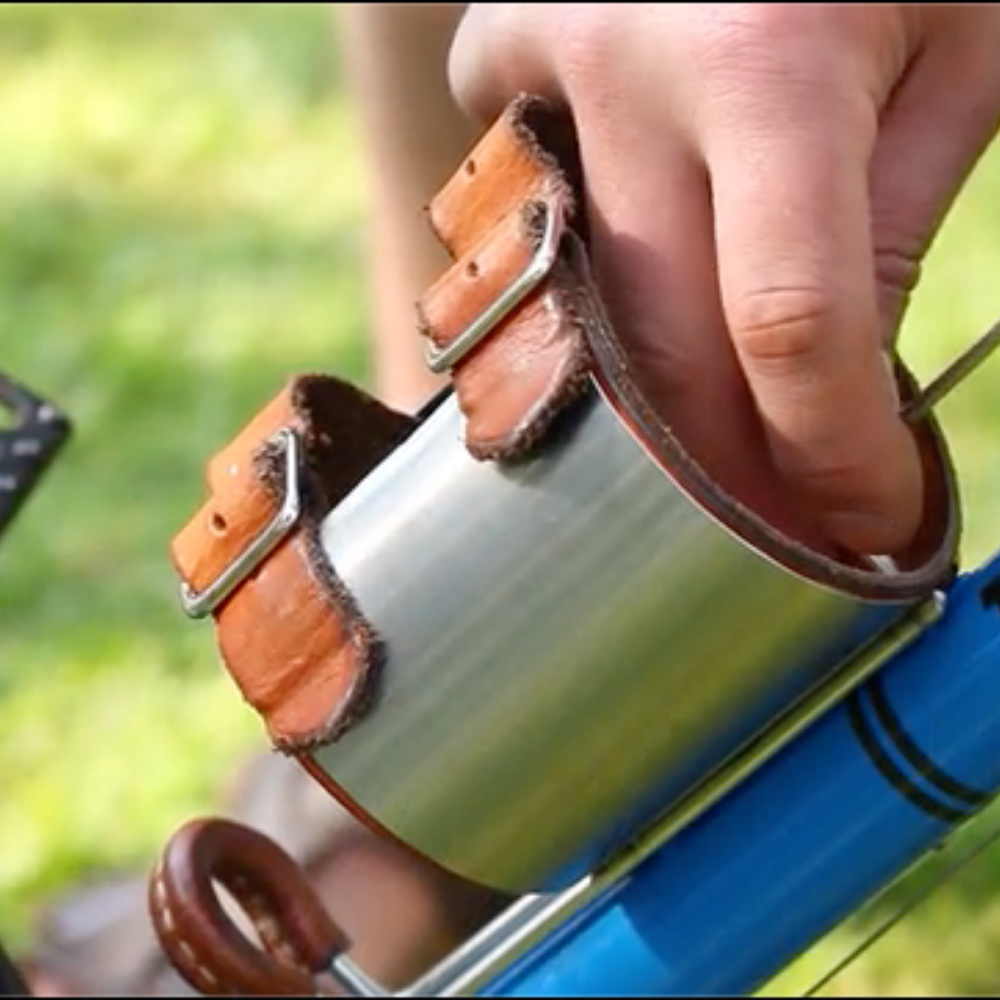 A single hand adjusting the diameter of the klean kanteen water bottle holder
