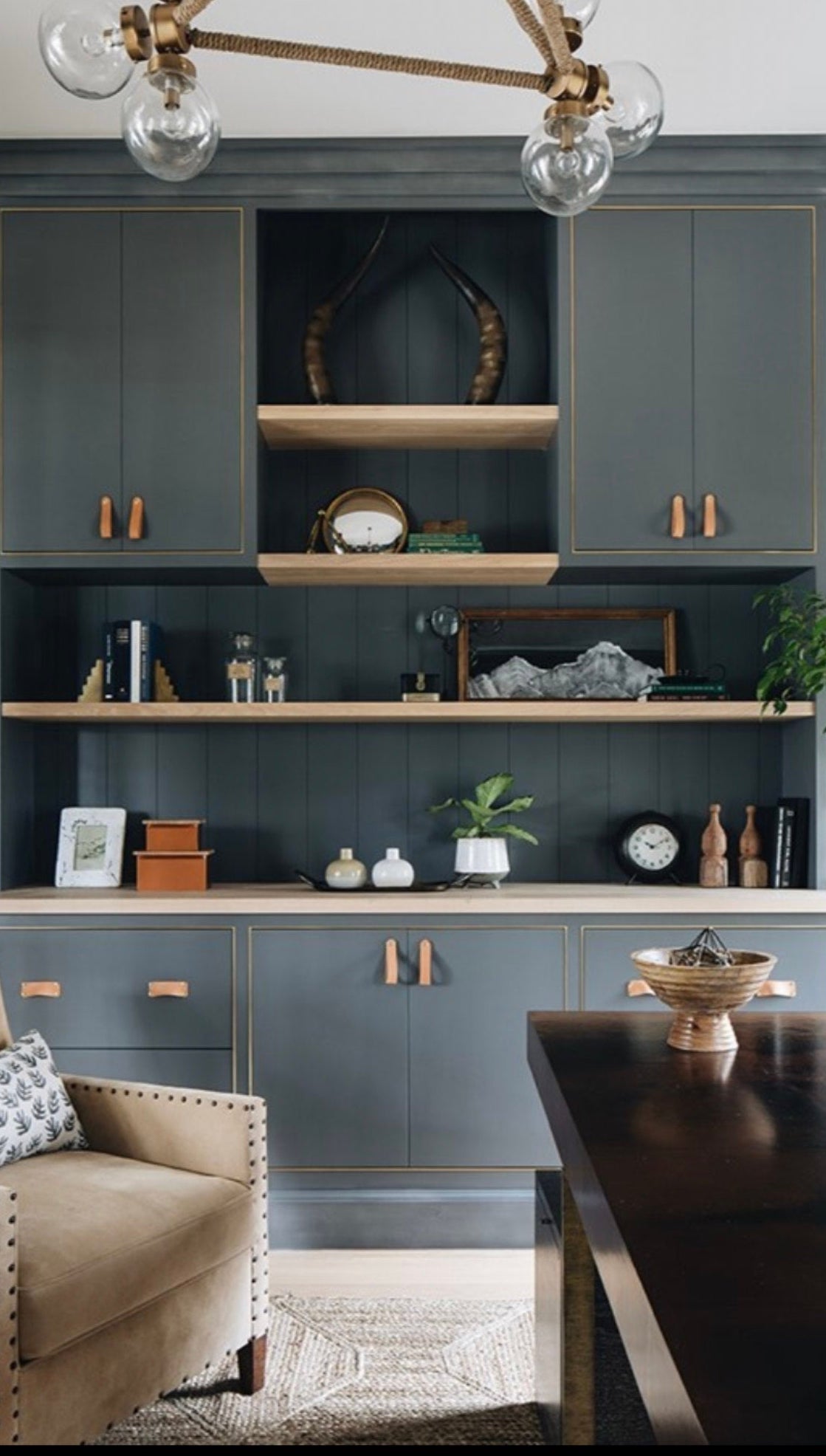 Customer photo of an elegant home library/study with a wall of dark gray cabinets and natural leather handles. Natural leather Morrison bin pulls are on the drawers and Hawthorne on the cabinet doors.