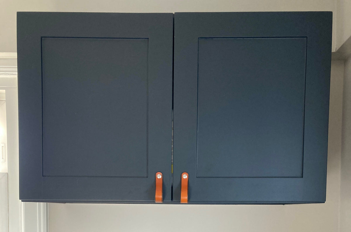 Customer photo showing a dark blue cabinet with honey leather Lovejoy cabinet handles. The two colors make a stunning contrast. 