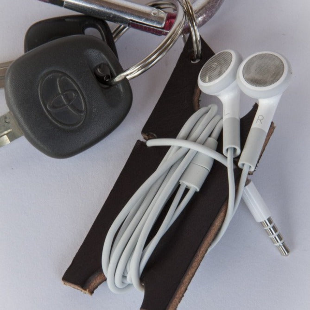 Black leather earbud cord organizer attached to carabiner