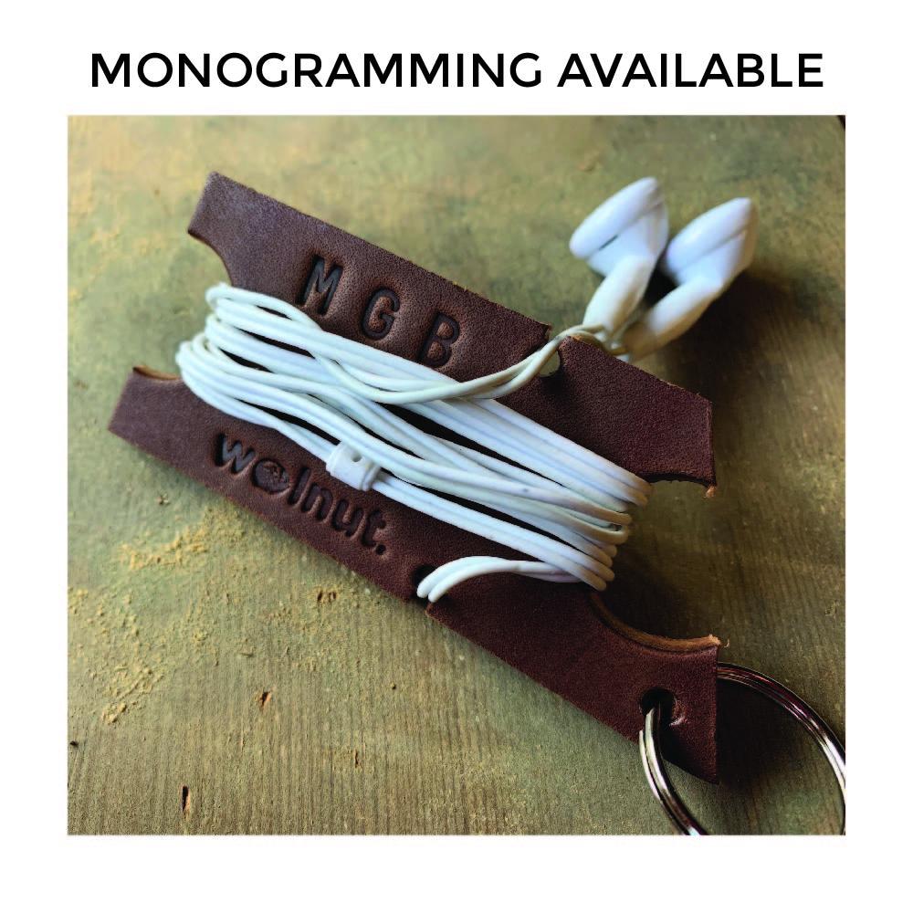 Dark brown leather headphone holder with text above that says &quot;Monogramming Available&quot;