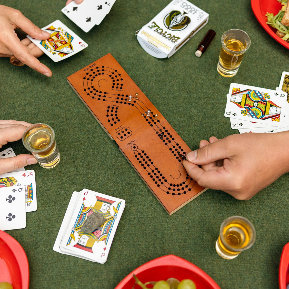 Three People Playing On A Folding Three-Track Leather Cribbage Board at a Picnic