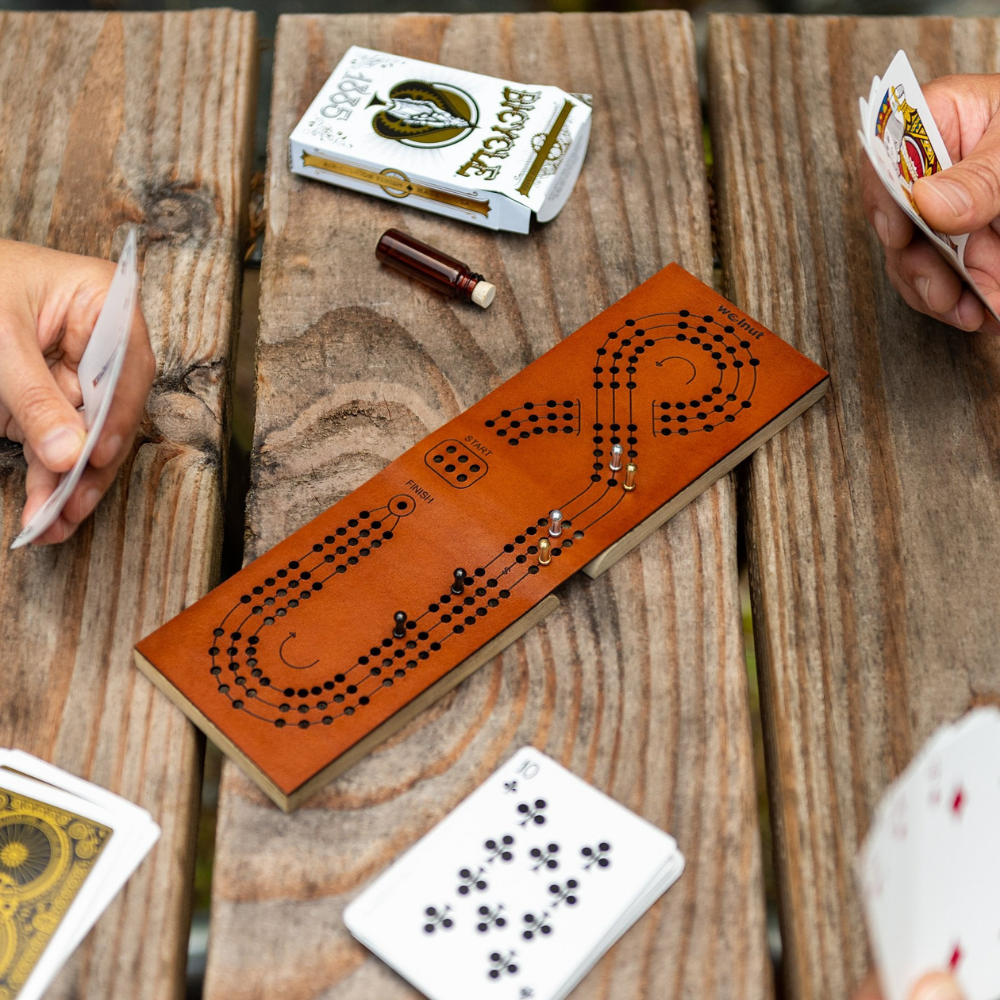 Close-up Scene of Two People Playing Travel Cribbage on Picnic Table in Oregon